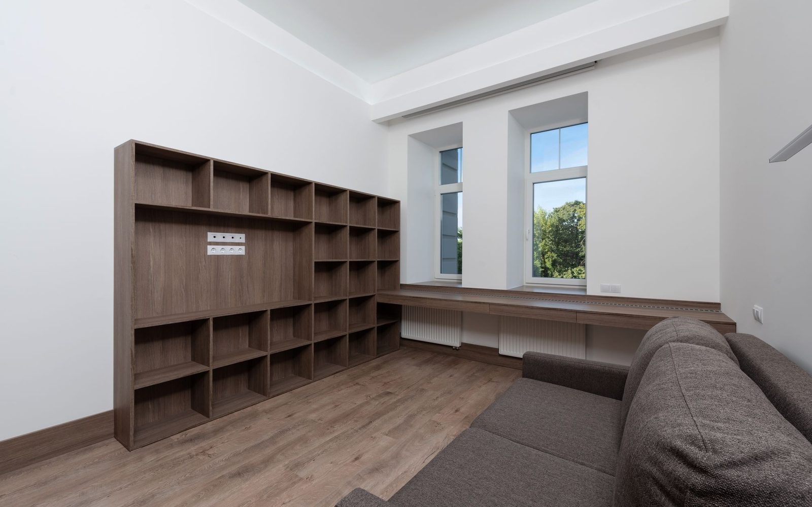 Built-in timber shelving unit in a plain white room