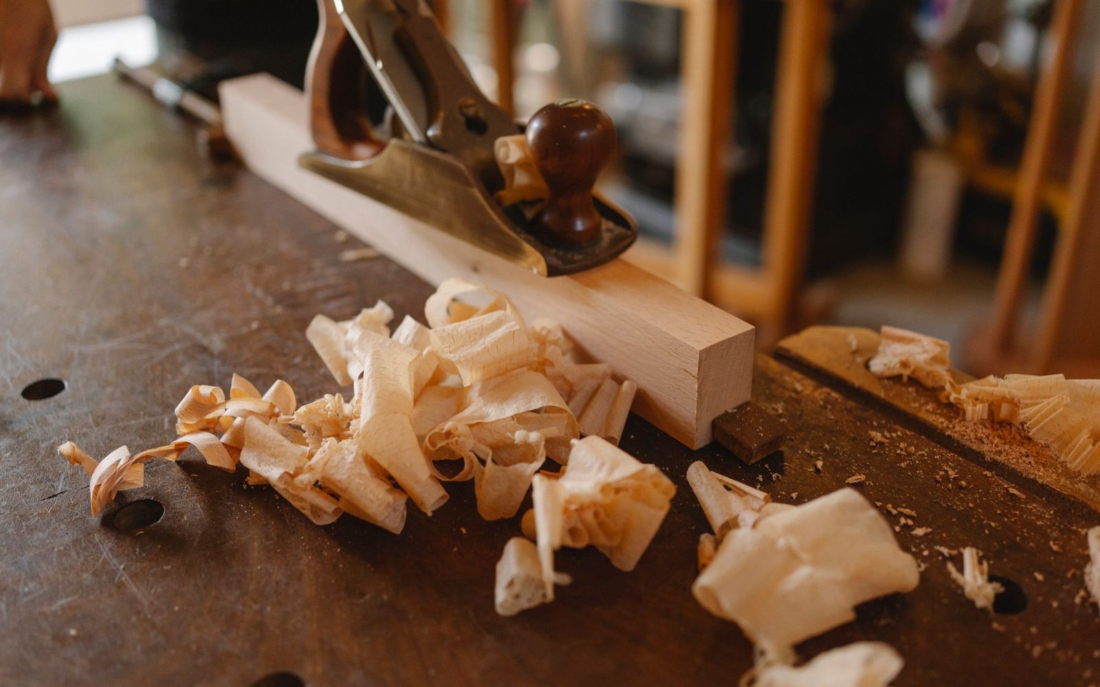 Hand plane and shavings on a joiner's workbench
